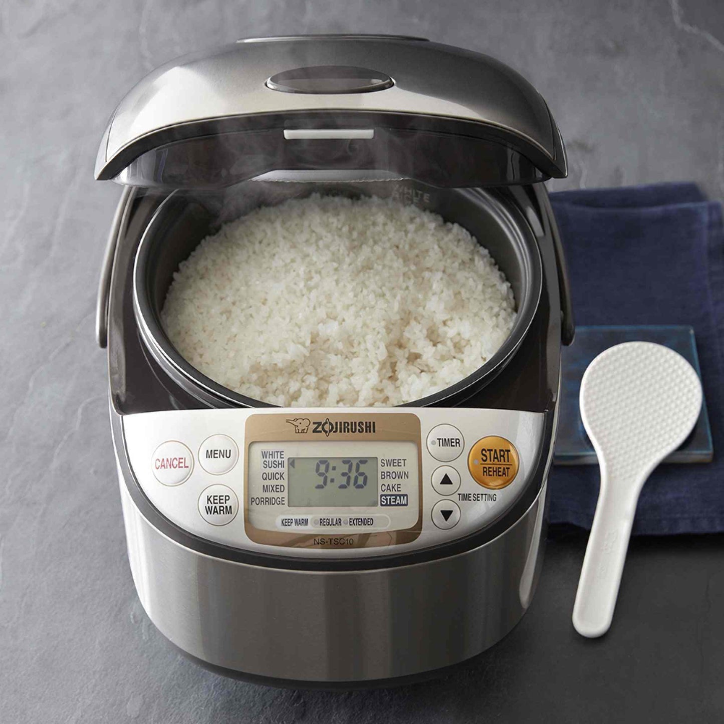 Zojirushi NS-TSC10 Micom rice cooker with fuzzy logic, LCD display, steaming basket, and multiple cooking settings.