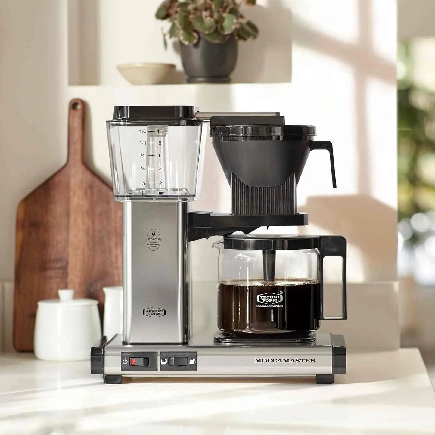Technivorm Moccamaster KBGV coffee maker brewing with 10-cup glass carafe and brew volume selector switch
