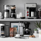 Wolf Gourmet automatic drip coffee maker with 10-cup capacity, stainless steel finish, and digital control panel.