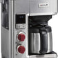 Wolf Gourmet automatic drip coffee maker with 10-cup capacity, stainless steel finish, and brewing carafe on a countertop.